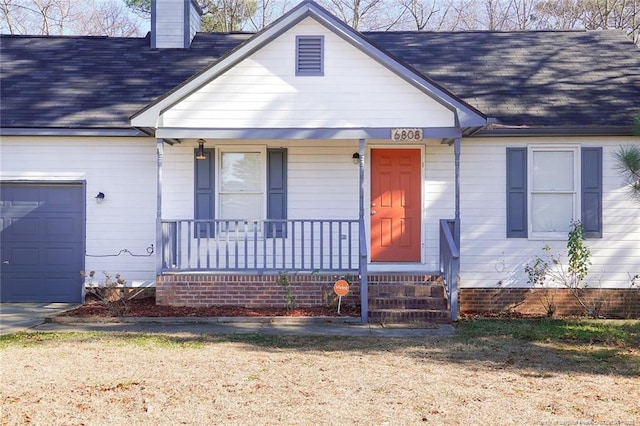 view of front facade with covered porch and a garage