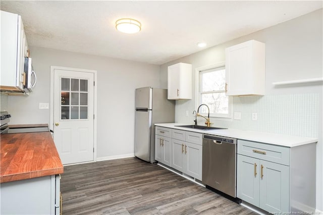 kitchen with white cabinets, stainless steel appliances, gray cabinetry, and sink