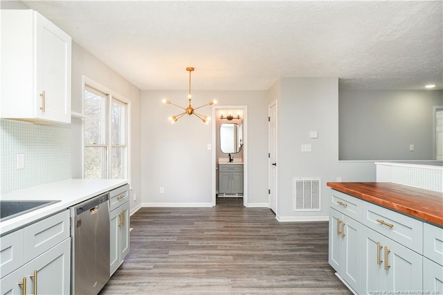 kitchen with pendant lighting, dishwasher, decorative backsplash, dark hardwood / wood-style flooring, and white cabinetry