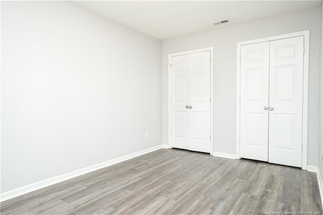 unfurnished bedroom featuring hardwood / wood-style flooring