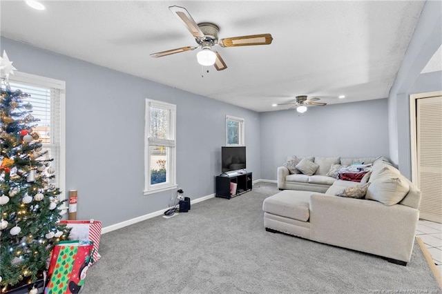 carpeted living room with ceiling fan