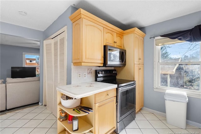 kitchen featuring backsplash, light brown cabinets, light tile patterned flooring, and appliances with stainless steel finishes