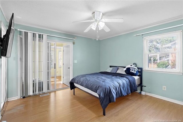 bedroom with ceiling fan, light hardwood / wood-style flooring, and crown molding