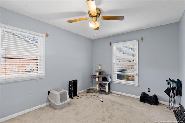 misc room featuring ceiling fan and light colored carpet