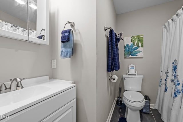 bathroom featuring a shower with curtain, toilet, and vanity