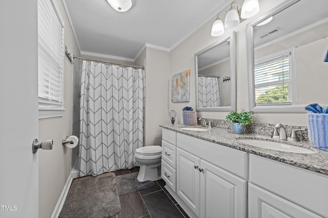 bathroom with toilet, vanity, and ornamental molding