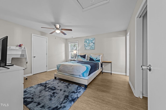 bedroom with ceiling fan and hardwood / wood-style flooring