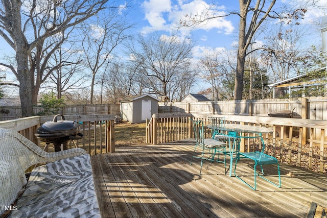 deck featuring a shed and area for grilling