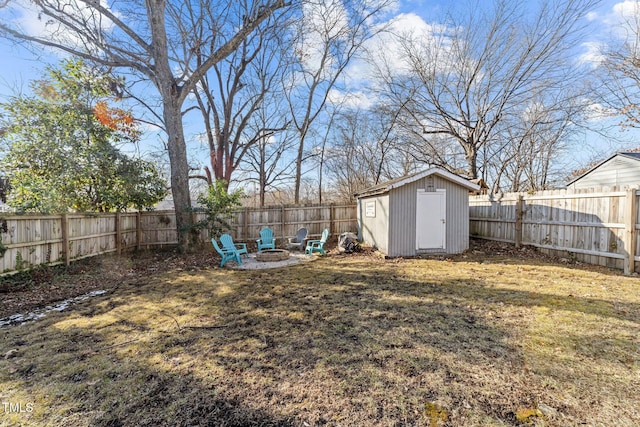 view of yard with a storage shed and a fire pit