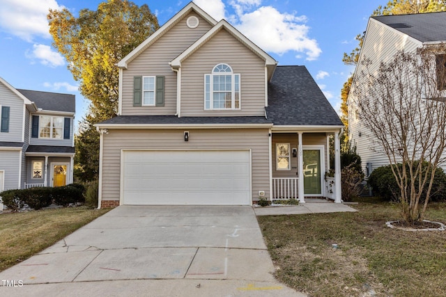 view of property featuring a garage and a front yard