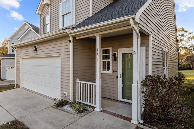 entrance to property featuring a porch and a garage