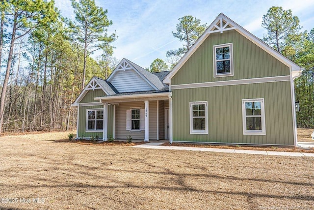 view of front of home with a front lawn and roof with shingles