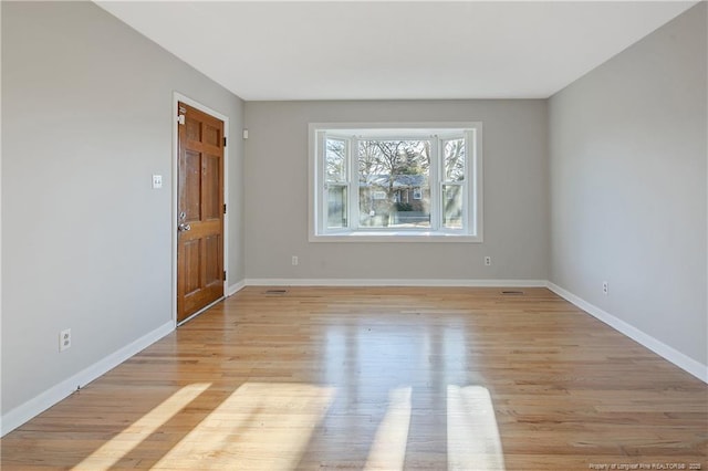 spare room with light wood-type flooring