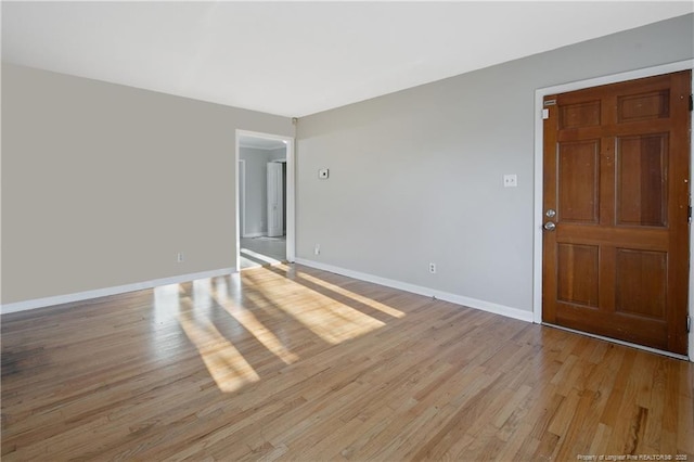 spare room with light hardwood / wood-style flooring