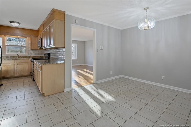 kitchen with a notable chandelier, decorative light fixtures, stainless steel appliances, and a wealth of natural light