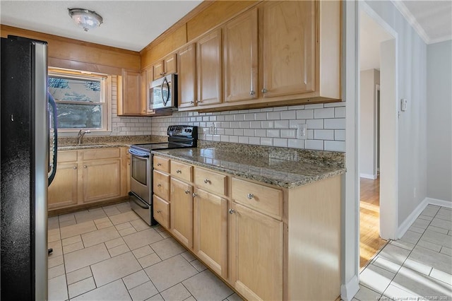 kitchen with tasteful backsplash, light stone counters, sink, and stainless steel appliances