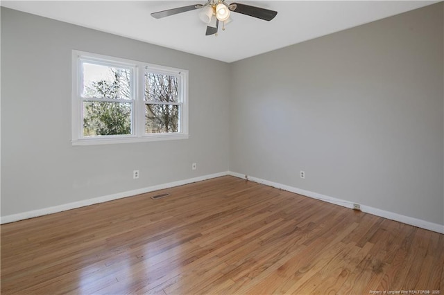 empty room featuring ceiling fan and wood-type flooring