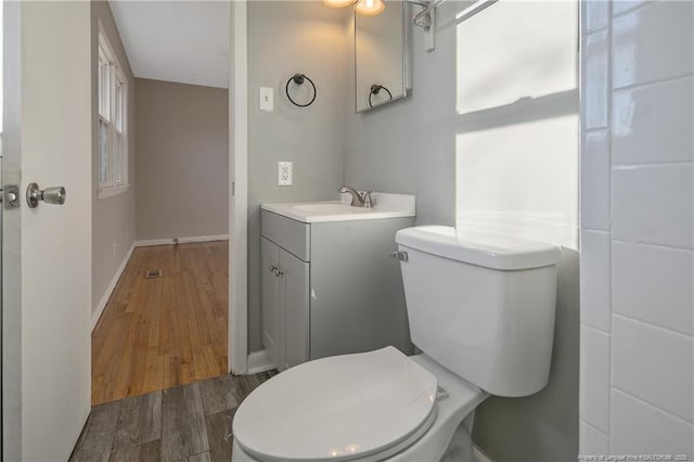 bathroom featuring hardwood / wood-style floors, vanity, and toilet