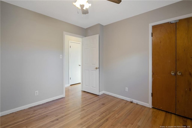 unfurnished bedroom featuring light wood-type flooring, a closet, and ceiling fan