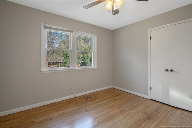 spare room featuring light hardwood / wood-style flooring and ceiling fan