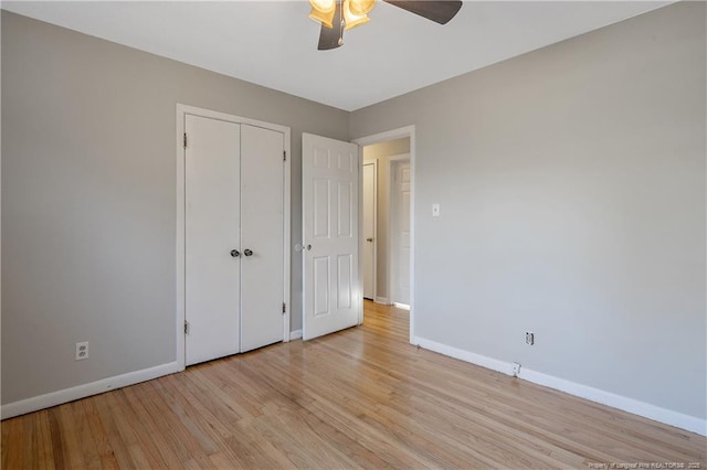 unfurnished bedroom with ceiling fan, light hardwood / wood-style floors, and a closet