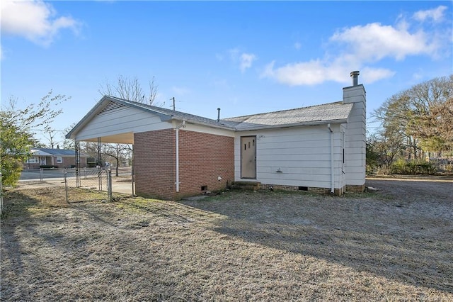 back of property featuring a carport