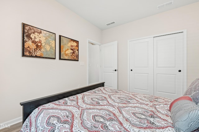 bedroom featuring hardwood / wood-style floors and a closet