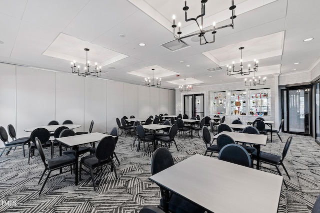 dining room with an inviting chandelier, a tray ceiling, and carpet floors