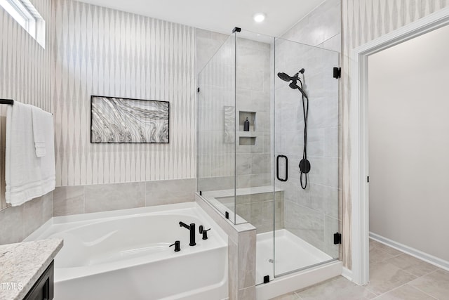 bathroom with vanity, tile patterned floors, and plus walk in shower