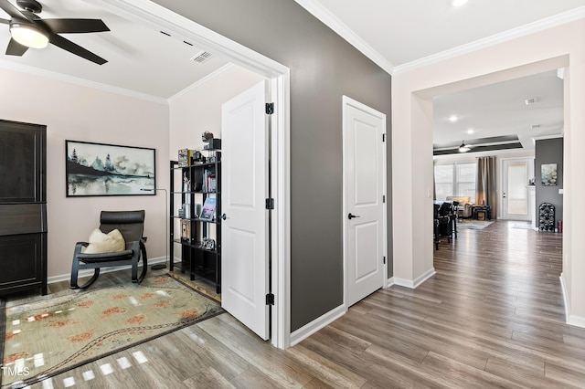 hallway featuring hardwood / wood-style floors and ornamental molding