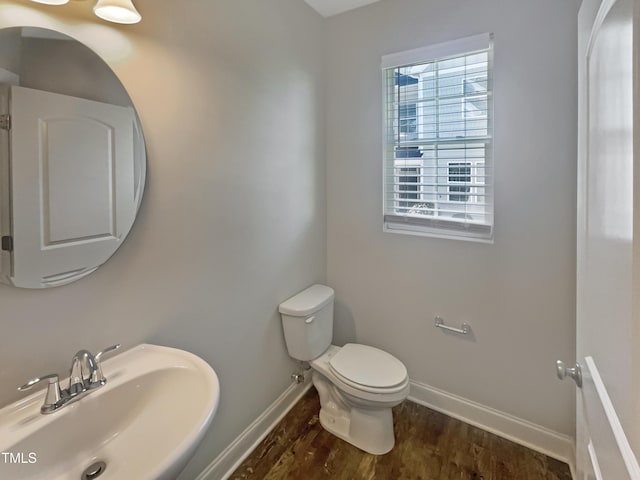 bathroom with hardwood / wood-style floors, toilet, and sink