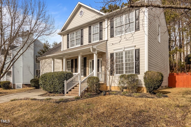 view of front of house featuring a porch and a front lawn