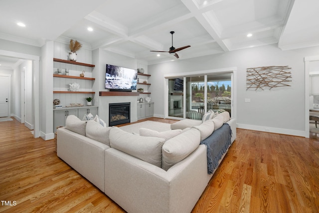 living room featuring coffered ceiling, beam ceiling, and light hardwood / wood-style flooring