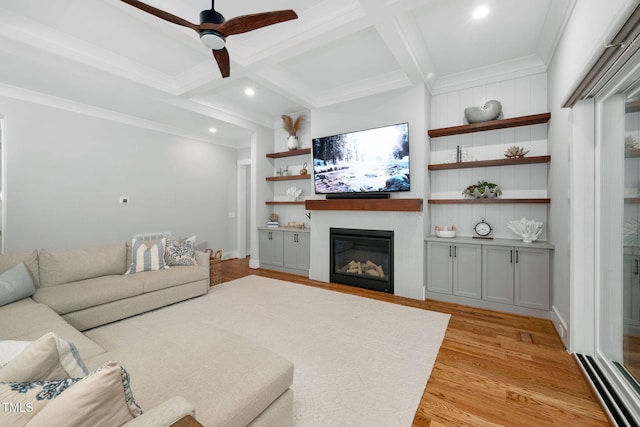 living room with coffered ceiling, light hardwood / wood-style flooring, ornamental molding, ceiling fan, and beam ceiling