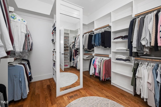 spacious closet featuring hardwood / wood-style floors