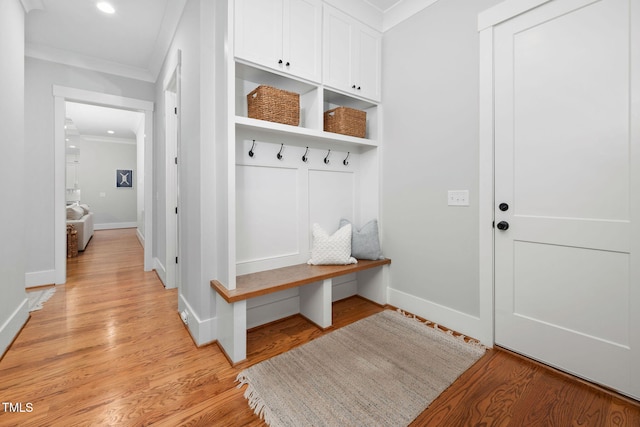 mudroom featuring crown molding and light hardwood / wood-style floors