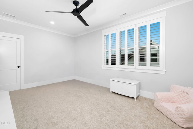 unfurnished room with light colored carpet, ornamental molding, and ceiling fan