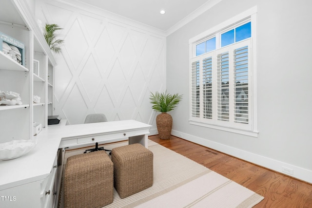 office space with wood-type flooring and ornamental molding