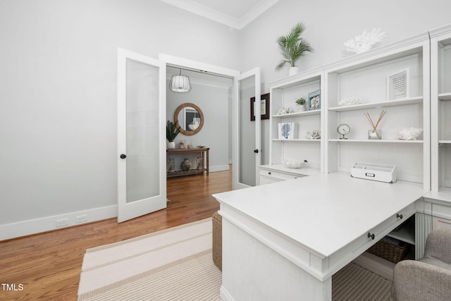 office space with crown molding, light hardwood / wood-style floors, and french doors