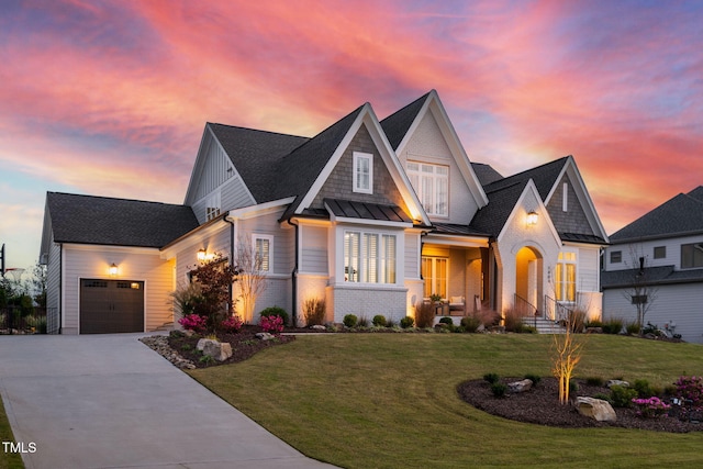 view of front of house featuring a garage and a lawn