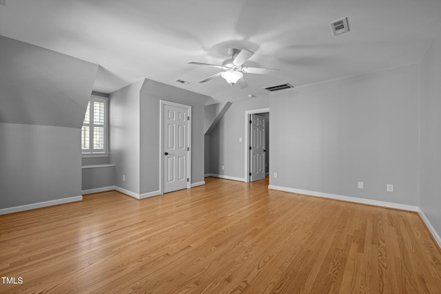 bonus room with light wood-type flooring, baseboards, and visible vents