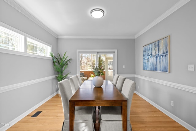 dining area featuring plenty of natural light, baseboards, and wood finished floors