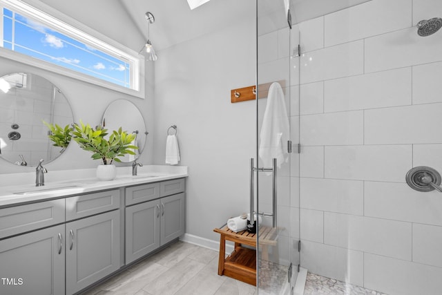 full bath with vaulted ceiling, double vanity, a sink, and a shower stall