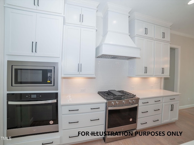 kitchen with white cabinets, decorative backsplash, appliances with stainless steel finishes, ornamental molding, and premium range hood