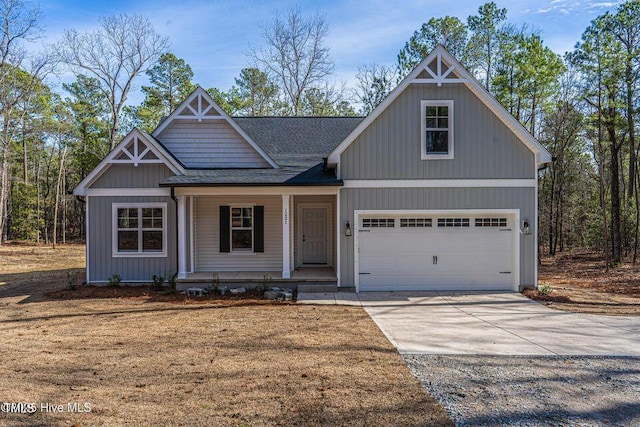 view of front of property featuring an attached garage, covered porch, a shingled roof, and concrete driveway