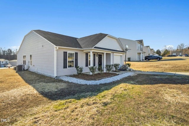 view of front of home featuring central air condition unit, a front yard, and a garage