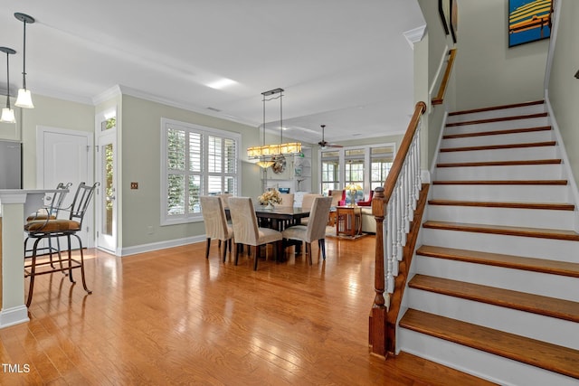 dining room with ornamental molding, light hardwood / wood-style floors, and plenty of natural light