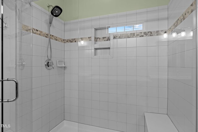 bathroom with a shower with door