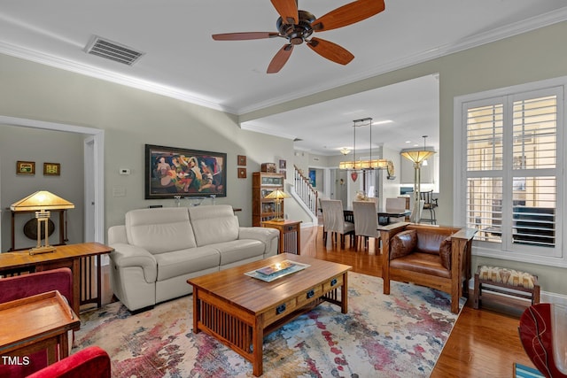 living room with ceiling fan, light hardwood / wood-style flooring, and crown molding