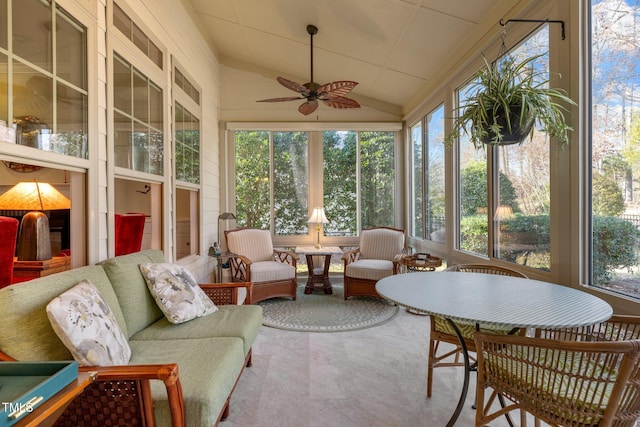 sunroom with lofted ceiling, ceiling fan, and plenty of natural light